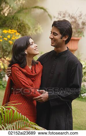 husband and wife in garden embracing, smiling at each other View Large Photo Image Stock Photo - husband and wife in garden embracing, smiling at each other. Fotosearch