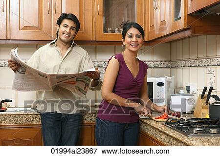 Husband and wife in kitchen View Large Photo Image Stock Photo - Husband and wife in kitchen. Fotosearch