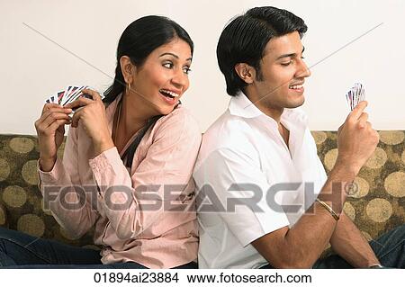 Picture - Husband and wife playing cards. Fotosearch