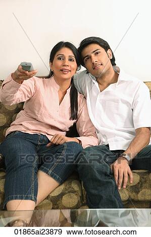 Stock Photo - Husband and wife watching tv. Fotosearch