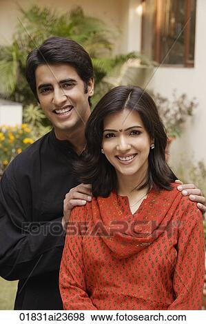 husband with hands on wife's shoulders, smiling at camera View Large Photo Image Stock Photo - husband with hands on wife's shoulders, smiling at camera. Fotosearch