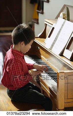 Little boy playing piano View Large Photo Image Picture - Little boy playing piano. Fotosearch