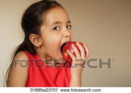Stock Photo - little girl biting into apple. Fotosearch