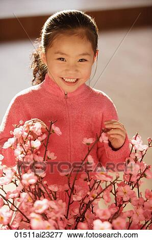 Stock Photo - Little girl with cherry blossom branches. Fotosearch