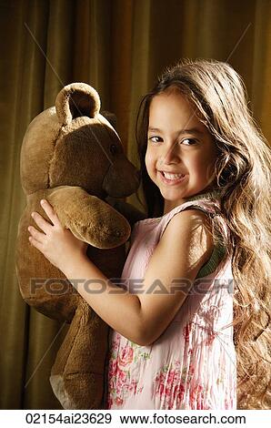 little girl with very long hair holding teddy bear View Large Photo Image Stock Photo - little girl with very long hair holding teddy bear. Fotosearch