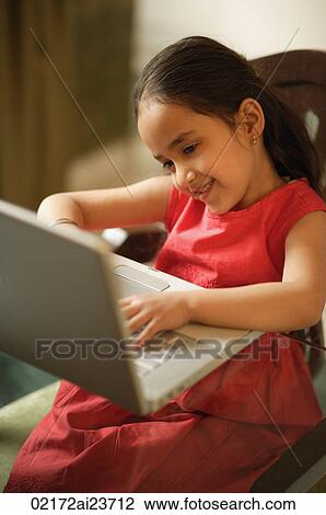 little girl working at laptop (vertical) View Large Photo Image Stock Image - little girl working at laptop (vertical). Fotosearch