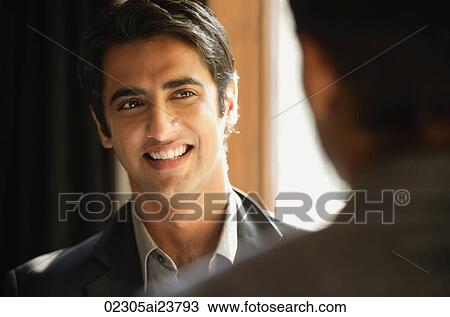 Stock Image - male colleagues talking (close-up, horizontal). Fotosearch