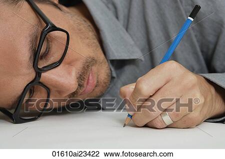 Man head down drawing on paper with pencil View Large Photo Image Stock Image - Man head down drawing on paper with pencil. Fotosearch