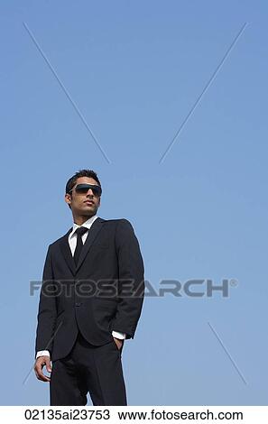 Stock Image - man in dark suit, dark glasses. Fotosearch