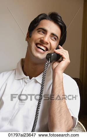 man laughs while talking on phone View Large Photo Image Stock Photo - man laughs while talking on phone. Fotosearch