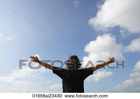 Man looking at the sky, arms outstretched View Large Photo Image Stock Image - Man looking at the sky, arms outstretched. Fotosearch