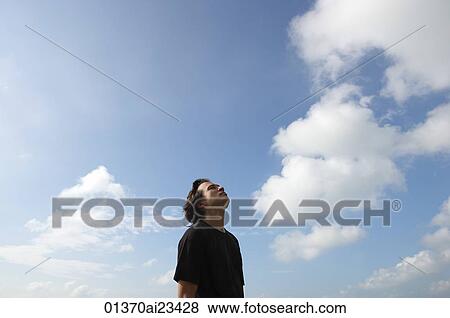 Stock Photo - Man looking at the sky. Fotosearch
