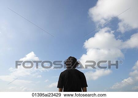 Stock Photo - Man looking at the sky. Fotosearch