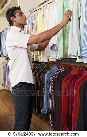 Stock Photo - man shopping for shirts. Fotosearch