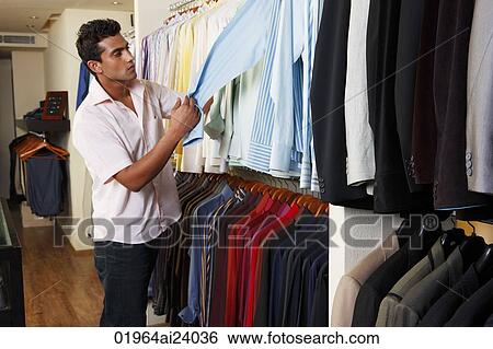 Stock Photograph - man shopping for shirts. Fotosearch