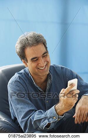 Man with gray hair smiling and checking messages View Large Photo Image Stock Photography - Man with gray hair smiling and checking messages. Fotosearch