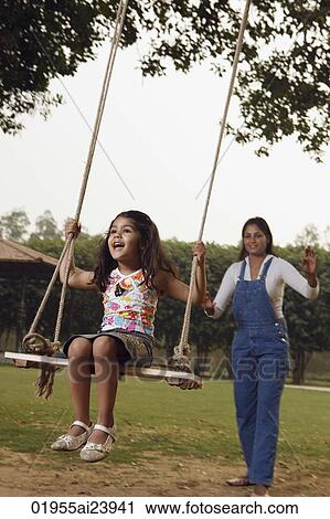 mom pushing daughter in swing View Large Photo Image Stock Image - mom pushing daughter in swing. Fotosearch