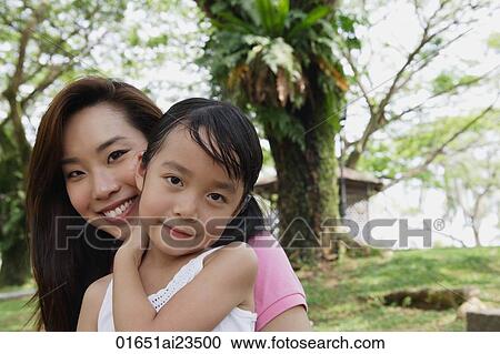 Mother and daughter at the park, both looking at camera View Large Photo Image Stock Image - Mother and daughter at the park, both looking at camera. Fotosearch