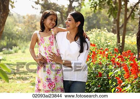 Mother and daughter hugging in park View Large Photo Image Picture - Mother and daughter hugging in park. Fotosearch