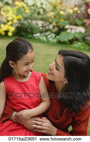 mother and daughter in garden, embracing, smiling at each other View Large Photo Image Stock Image - mother and daughter in garden, embracing, smiling at each other. Fotosearch