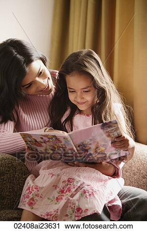 mother and daughter look at story book View Large Photo Image Stock Image - mother and daughter look at story book. Fotosearch