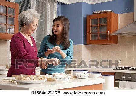 Mother and daughter making dumplings in the kitchen View Large Photo Image Stock Photo - Mother and daughter making dumplings in the kitchen. Fotosearch