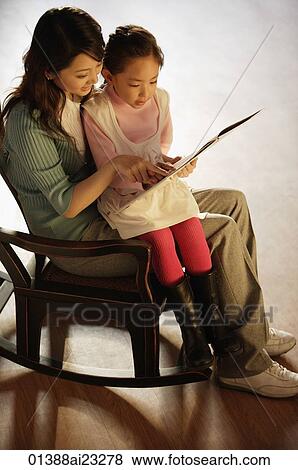 Mother and daughter on rocking chair reading a book View Large Photo Image Stock Photo - Mother and daughter on rocking chair reading a book. Fotosearch