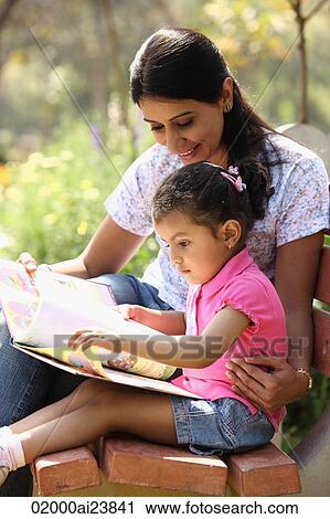 Mother and daughter with book View Large Photo Image Stock Image - Mother and daughter with book. Fotosearch