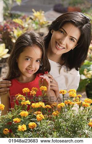 mother and daughter with flowers, smiling at camera View Large Photo Image Stock Image - mother and daughter with flowers, smiling at camera. Fotosearch