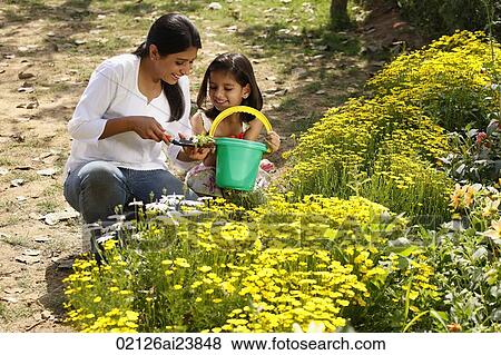 Mother and daughter with green pail View Large Photo Image Stock Photo - Mother and daughter with green pail. Fotosearch