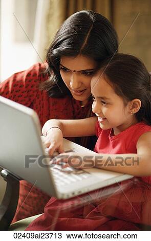 mother and daughter working at laptop (vertical) View Large Photo Image Stock Image - mother and daughter working at laptop (vertical). Fotosearch