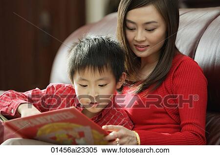 Stock Photography - Mother and son looking at children's book. Fotosearch