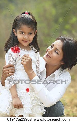 Mother hugging daughter, outside View Large Photo Image Stock Photo - Mother hugging daughter, outside. Fotosearch