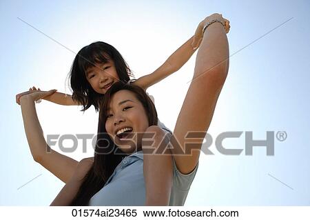 Mother piggybacking daughter smiling at the camera View Large Photo Image Stock Photography - Mother piggybacking daughter smiling at the camera. Fotosearch