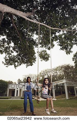 mother pushing daughter in swing View Large Photo Image Stock Image - mother pushing daughter in swing. Fotosearch