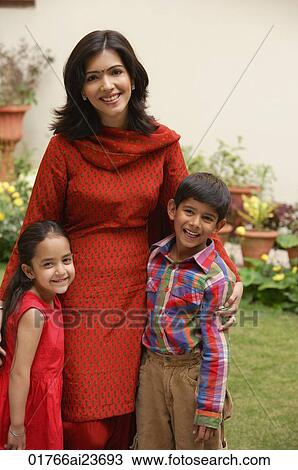 mother standing with son and daughter in garden, smiling at camera View Large Photo Image Stock Image - mother standing with son and daughter in garden, smiling at camera. Fotosearch
