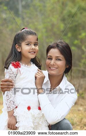 Mother with arms around daughter View Large Photo Image Stock Photo - Mother with arms around daughter. Fotosearch