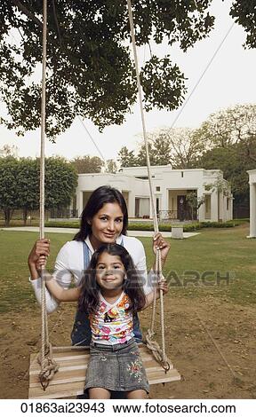 Stock Image - mother with girl on swing. Fotosearch
