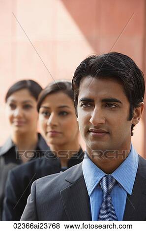 one businessman in foreground, two businesswomen in background (vertical) View Large Photo Image Stock Photo - one businessman in foreground, two businesswomen in background (vertical). Fotosearch