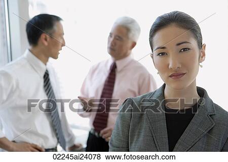 Stock Photo - one businesswoman, two businessmen. Fotosearch