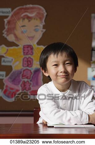 Schoolboy in class looking at camera View Large Photo Image Stock Photography - Schoolboy in class looking at camera. Fotosearch