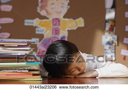 Stock Photograph - Schoolboy sleeping in class. Fotosearch