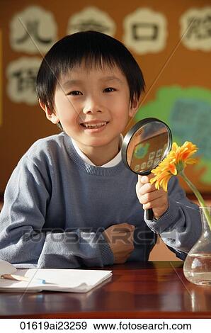 Stock Photo - Schoolboy with magnifying glass. Fotosearch