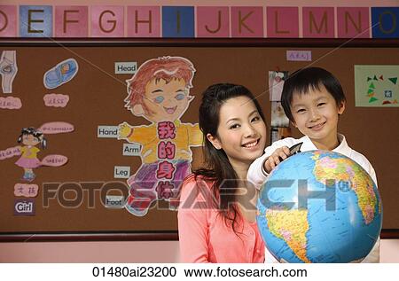 Schoolboy with teacher and globe View Large Photo Image Stock Image - Schoolboy with teacher and globe. Fotosearch