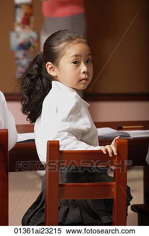 Schoolgirl in class turning head around looking at camera View Large Photo Image Stock Photography - Schoolgirl in class turning head around looking at camera. Fotosearch