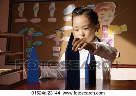 Schoolgirl with building blocks View Large Photo Image Picture - Schoolgirl with building blocks. Fotosearch