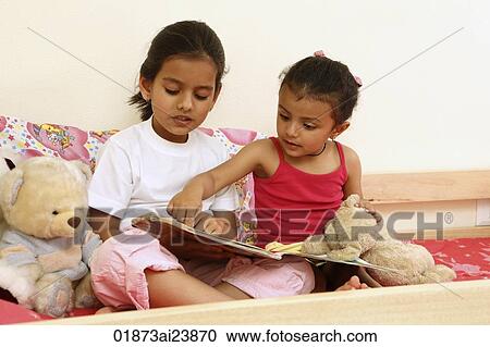 Sisters reading story book View Large Photo Image Stock Image - Sisters reading story book. Fotosearch
