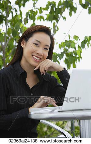sitting woman with hand on chin View Large Photo Image Stock Photo - sitting woman with hand on chin. Fotosearch