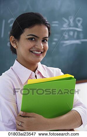 smiling teacher holding notebooks View Large Photo Image Stock Photo - smiling teacher holding notebooks. Fotosearch