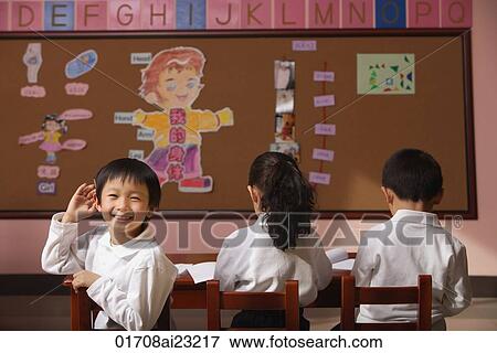 Students in class, schoolboy turning head around looking at camera View Large Photo Image Stock Photo - Students in class, schoolboy turning head around looking at camera. Fotosearch